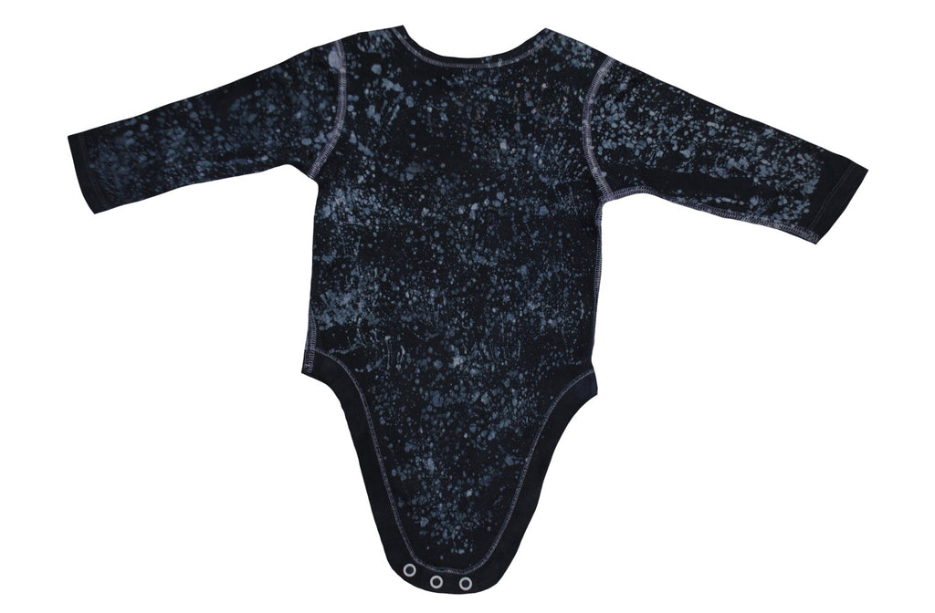 Close-up of blue bear onesie showing batik patterns and snap closures